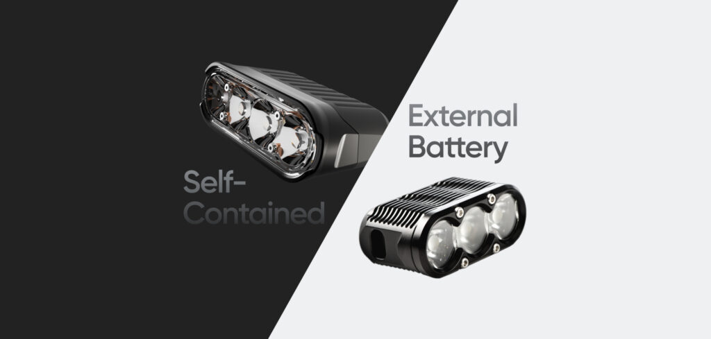 Side-by-side comparison of self-contained bike light with integrated battery and LEDs versus external battery light system with separate light head and battery pack connected by cable