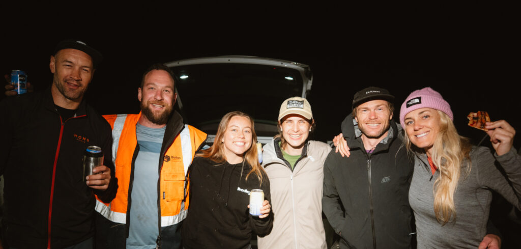 The Gloworm Lights production crew celebrating after wrapping the second night of shooting in Whakarewarewa Forest, Rotorua, with beers and pizza.